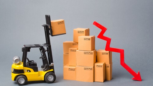 Yellow Forklift truck truckraises a box over a stack of boxes and red arrow down. Decrease in economic rates, low demand for goods, decrease in import or export. Reduced storage, logistics costs