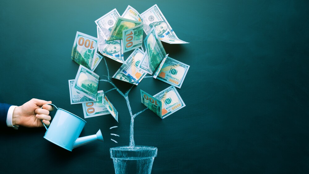 the businessman is watering money tree made by us dollar bills. Business, saving, growth, economic concept. Investors strategy, funding symbol. Copy space