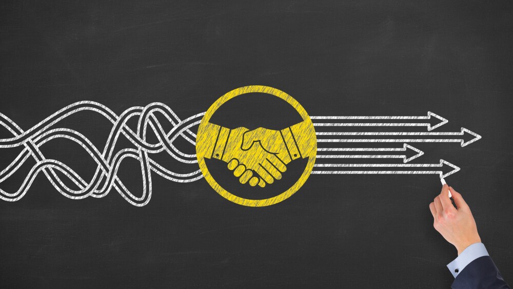 Solution Concept with Handshake on Chalkboard Background