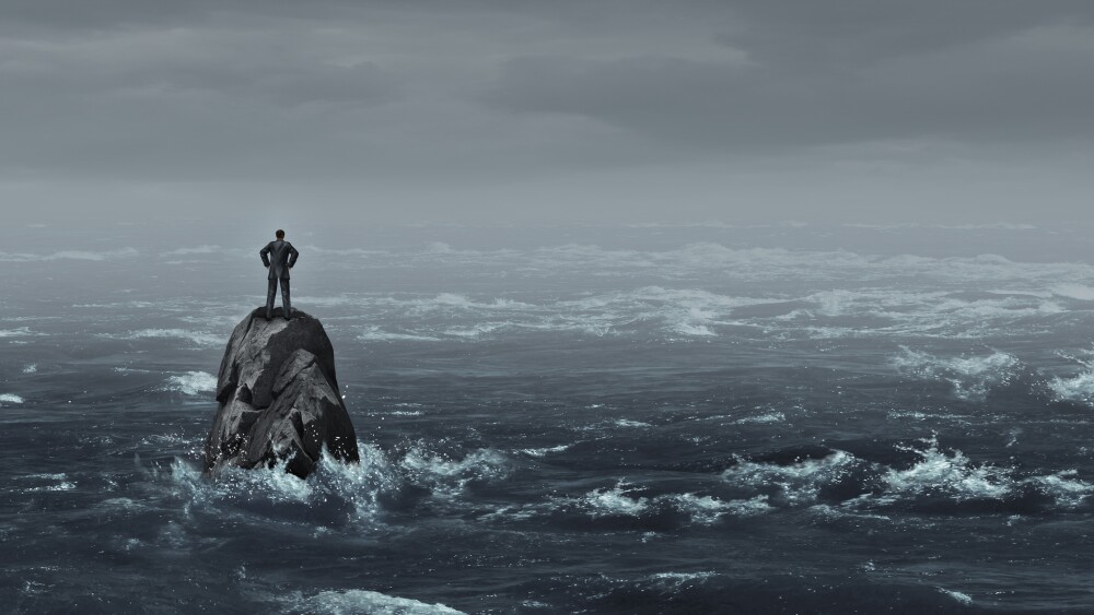 Business despair concept as a stranded businessman lost at sea standing on an isolated rock as a corporate idea for financial crisis or being lost and needing career or financial help to escape in a 3D illustration style.