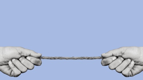 man pulling each of the opposite ends of a rope in black and white, on a blue background with some blank space on top