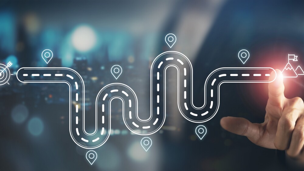 Business and Project Roadmap Concept. Touching on virtual screen with roadmap overlay representing steps in a project or strategic planning process. Waypoint icons and ends with goal achievement.