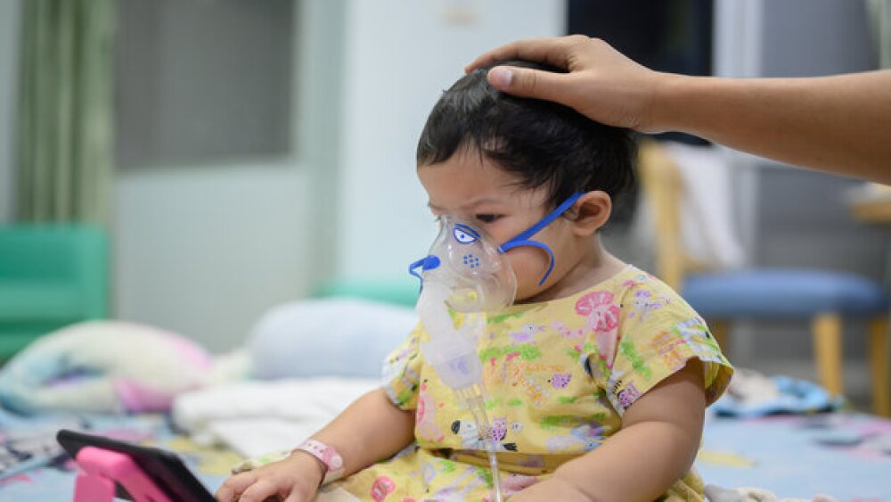 Pictured: Infant in the hospital wearing a ventila