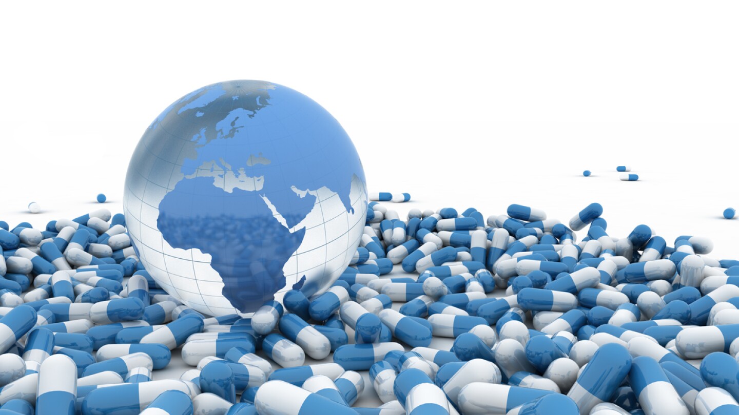 Blue pills and world globe on white background.