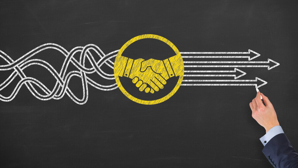 Solution Concept with Handshake on Chalkboard Background