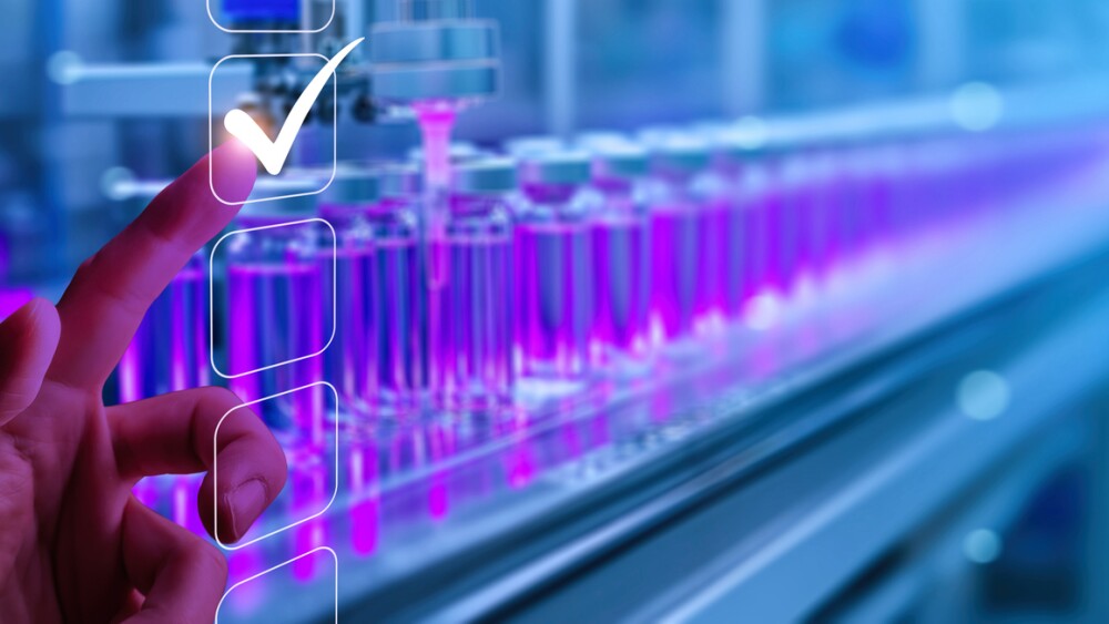 Hand touching virtual checklist with a checkmark, symbolizing approval, against backdrop of automated pharmaceutical production line