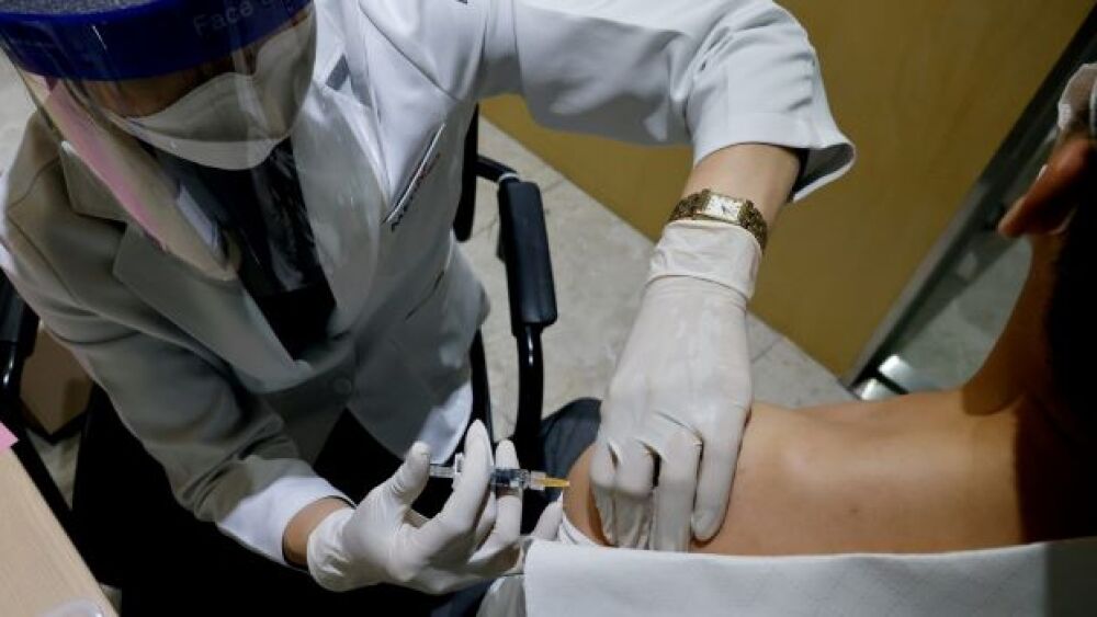 A man gets an influenza vaccine at a branch of the
