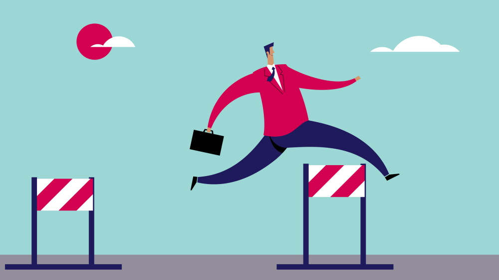 Business man jumping over barriers