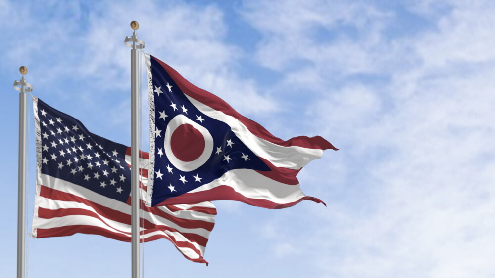 Ohio state flag waving in the wind with the national US flag on a clear day. 3D illustration render. Rippled textile. Selective focus