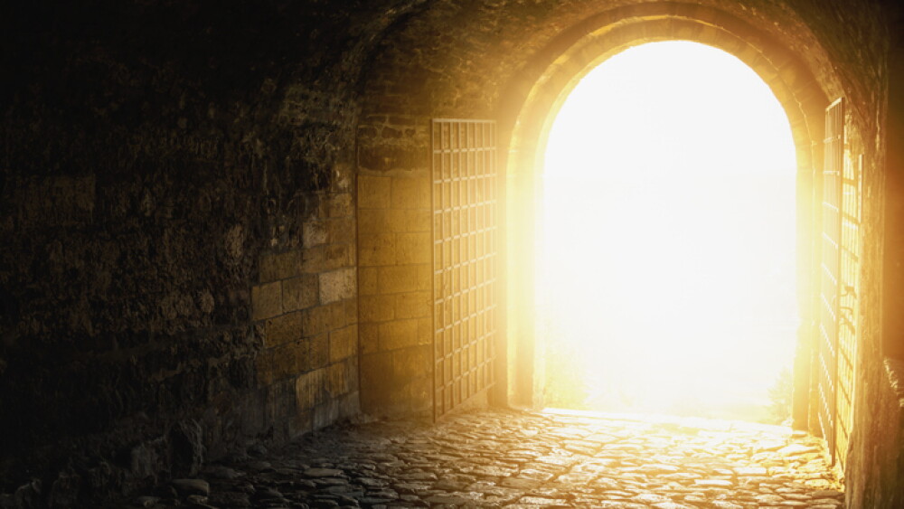 Door to Heaven. Arched passage open to heaven`s sky. Light at end of the tunnel. Hope metaphor.