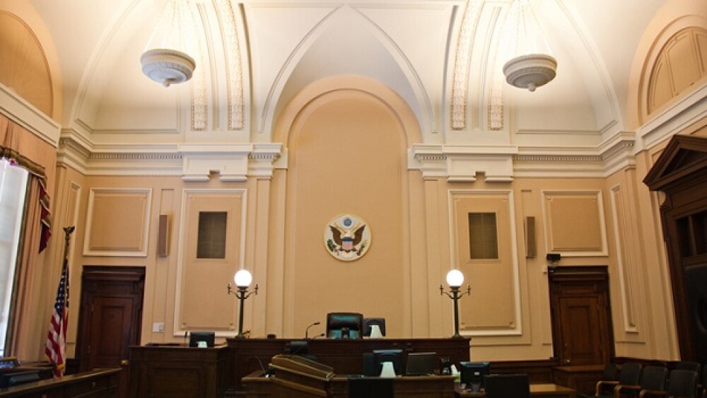 Pictured: The inside of a federal courtroom/iStock