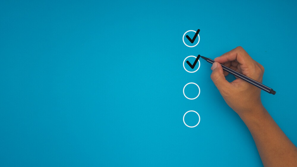 Handwriting check box on a blue background. Checklist and choice concept. Top view.