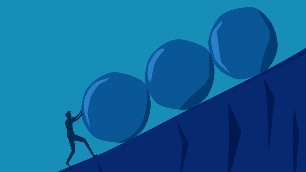 Determined man pushing several stones at once\