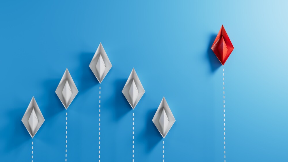 Group of paper boat in one direction and with one individual pointing in the different way. Business for innovative solution concept.3D rendering on blue background.