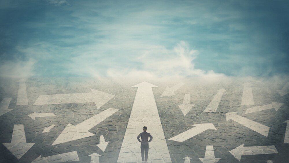 Doubtful person, hands on hips, choosing the way as multiple arrows on the road showing a mess of different directions. Choosing the correct pathway, difficult decision concept, confusion symbol.