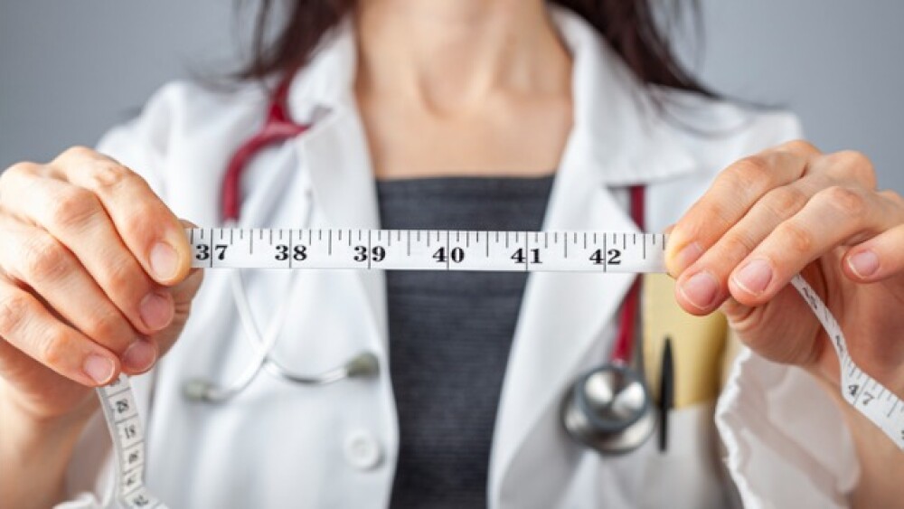 Pictured: Doctor with tape measure/iStock, Grandbr