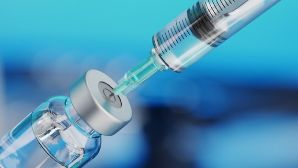 Pictured: Syringe drawing vaccine from a vial