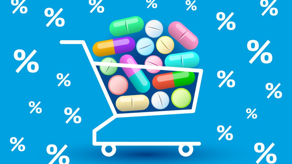 Many various colored tablets and pills are stacked in shopping cart, percent signs are around. Concept of buying of medicines, online sales of medication, discounts and promotions in pharmacy