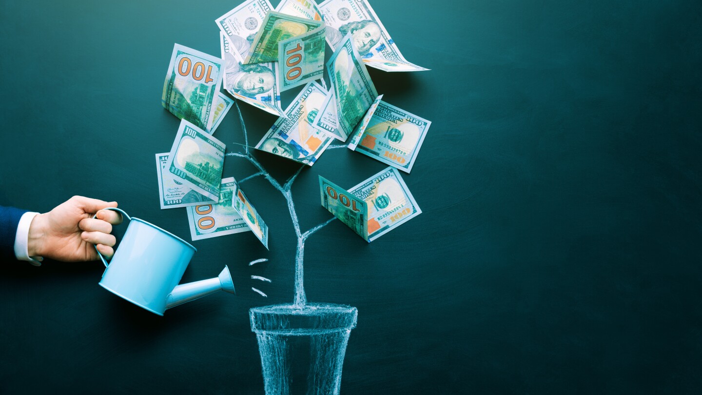 the businessman is watering money tree made by us dollar bills. Business, saving, growth, economic concept. Investors strategy, funding symbol. Copy space