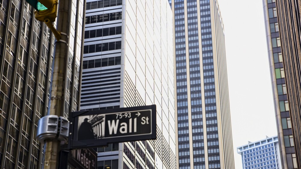 Wall Street sign with a background of skyscrapers in Lower Manhattan, New York City