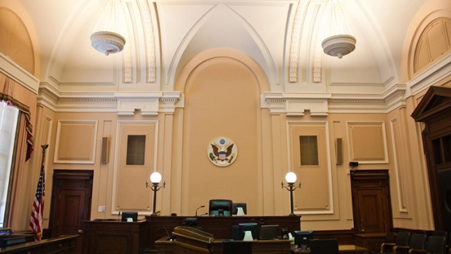 Pictured: The inside of a federal courtroom/iStock
