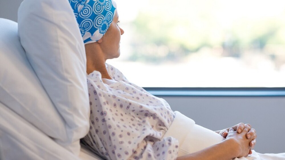 Cancer patient in bed looking out window