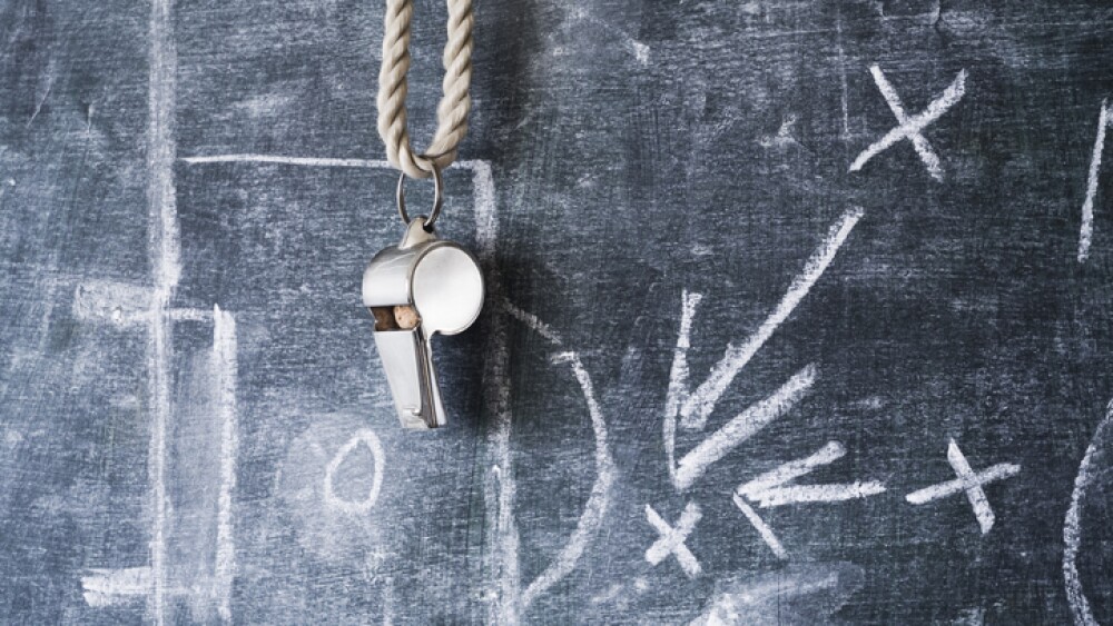 whistle of a soccer / football referee or coach on black board with tactical diagram