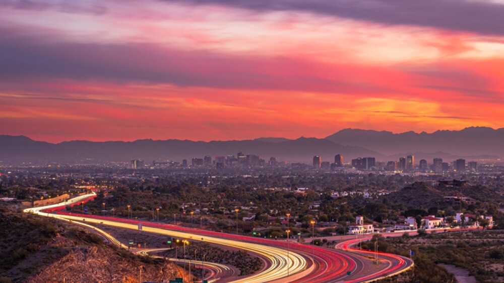 Highway in Phoenix, Arizona leading toward downtown at sunset