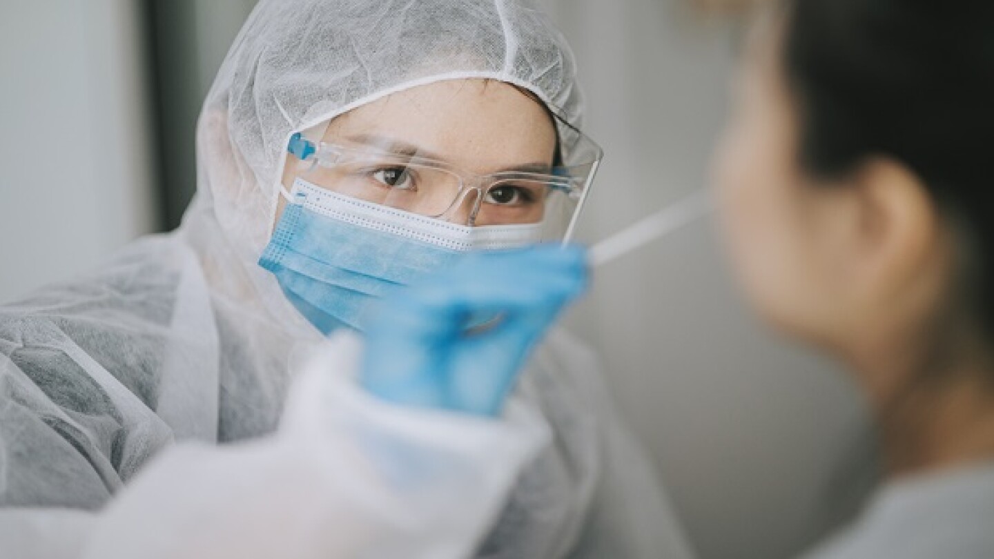 Pictured: Medical professional giving COVID Test/C