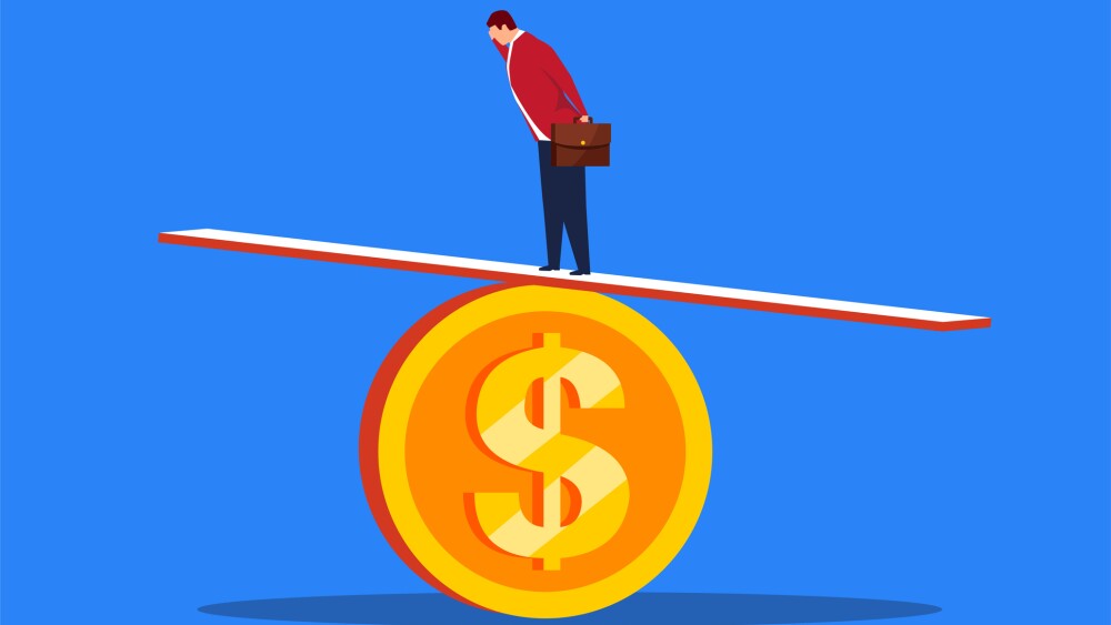 Businessman keeps the seesaw balanced