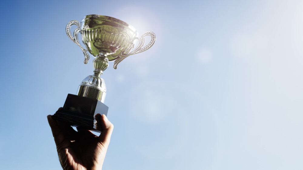 Celebrating with trophy award for success or first place sporting championship win