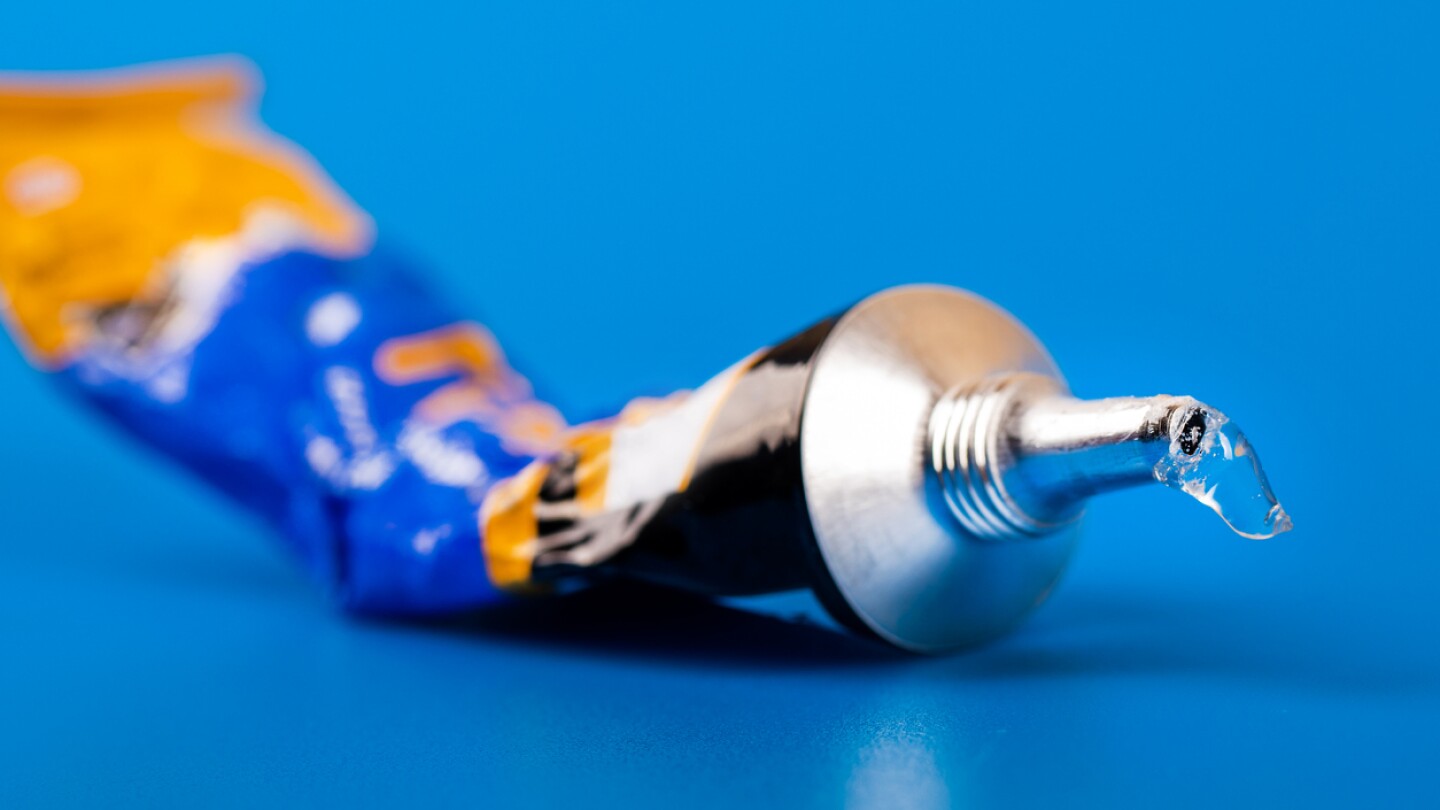 super glue tube on blue background