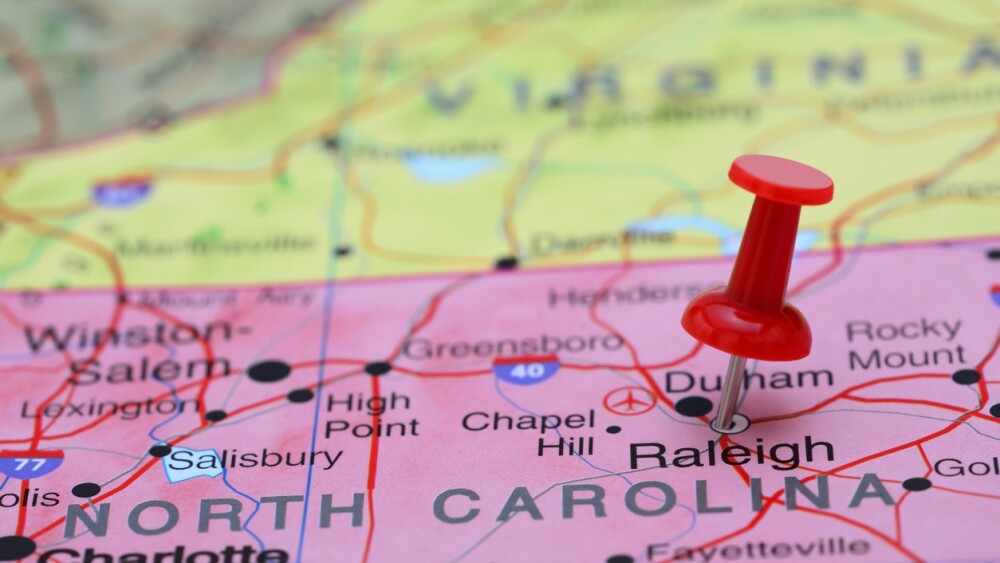 Photo of pinned Raleigh on a map of USA. May be used as illustration for traveling theme.