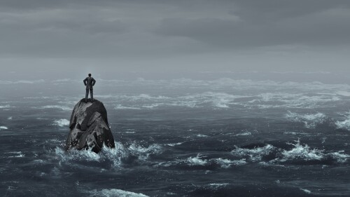 Business despair concept as a stranded businessman lost at sea standing on an isolated rock as a corporate idea for financial crisis or being lost and needing career or financial help to escape in a 3D illustration style.