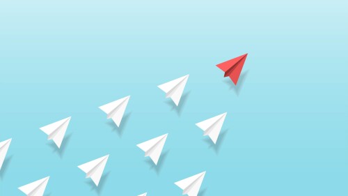Illustration of red paper plane leading white paper planes up into the sky