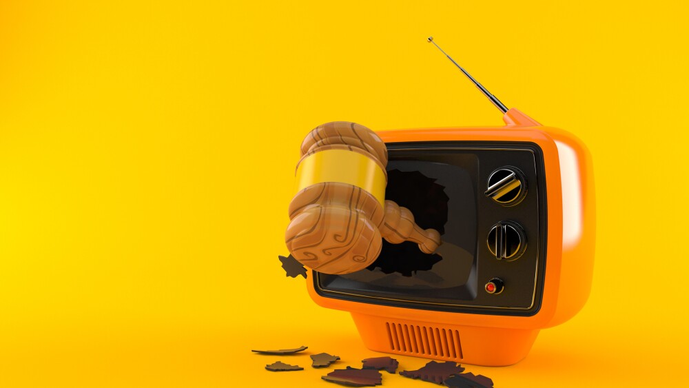Gavel inside tv isolated on orange background. 3d illustration