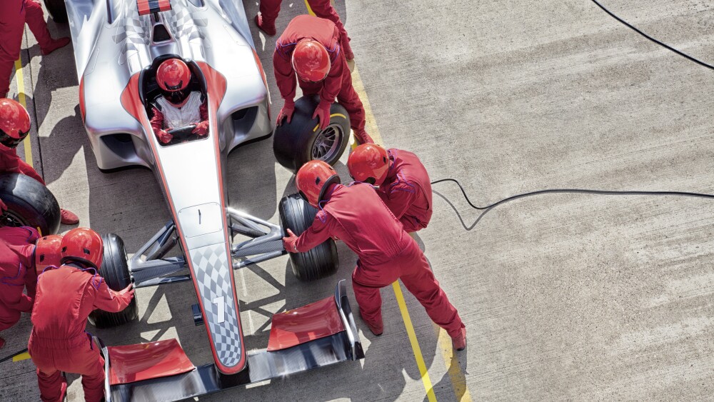 A pit crew working on a race car