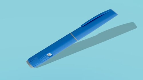 Photo of a GLP-1 injector pen on a blue background