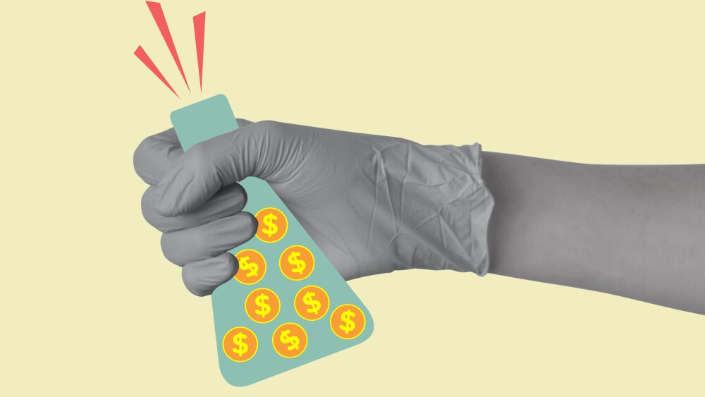 A hand in a medical or laboratory glove holds a laboratory flask with coins with dollar sign. Investments in laboratory research and science. Concept of profit, making money, business. Modern design. Copy space.