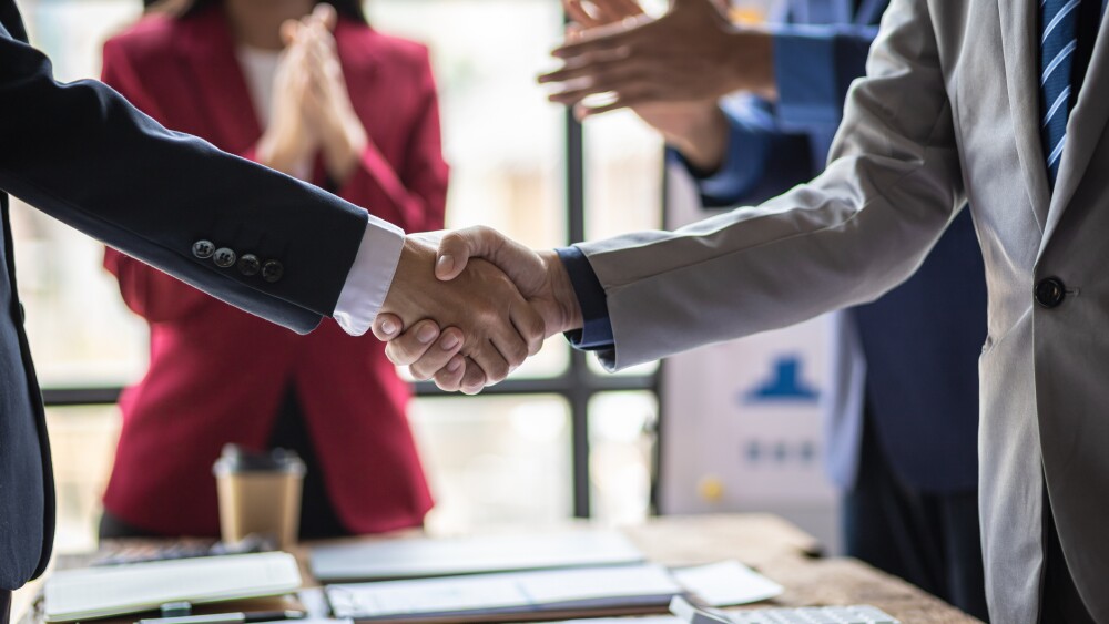 Business partners shaking hands after closing a deal