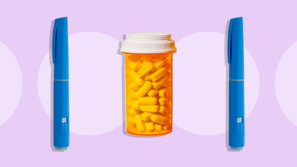 A pill bottle in between two injector pens