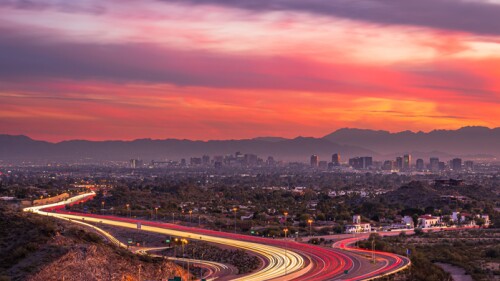Highway in Phoenix, Arizona leading toward downtown at sunset