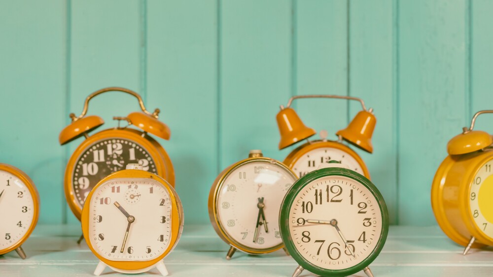 Retro styled image of a set of different colorful alarm clocks