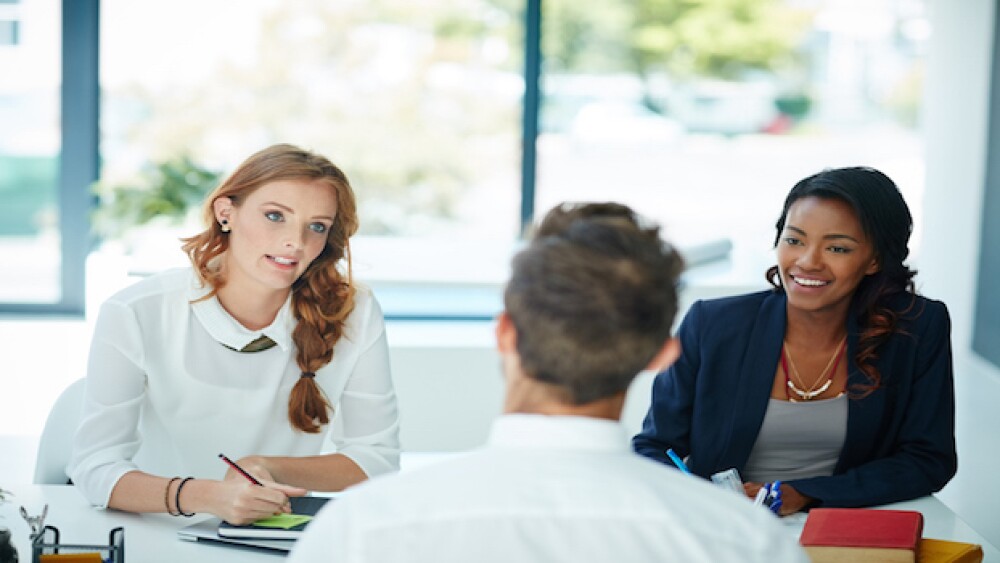 Cropped shot of a man being interviewed by two businesswomen in an office