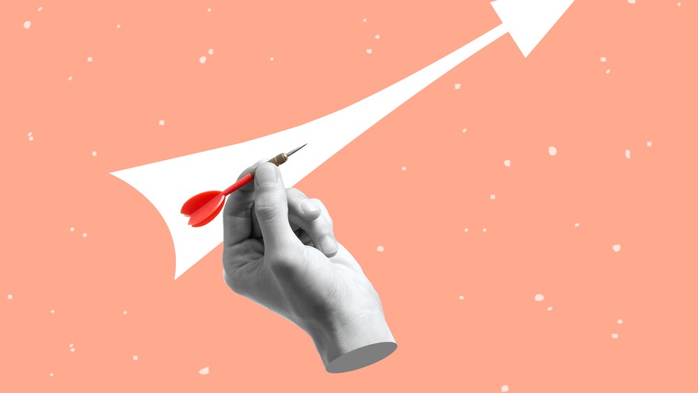 Contemporary art collage of hand holding a dart aiming at the target. Business targeting, aiming, focus concept. Modern design. Copy space.