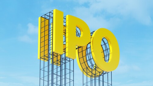 Large yellow signboard on metal frame with the word IPO. Clear sky in the background. Concept of share trading on stock market, capital investment, currency exchange