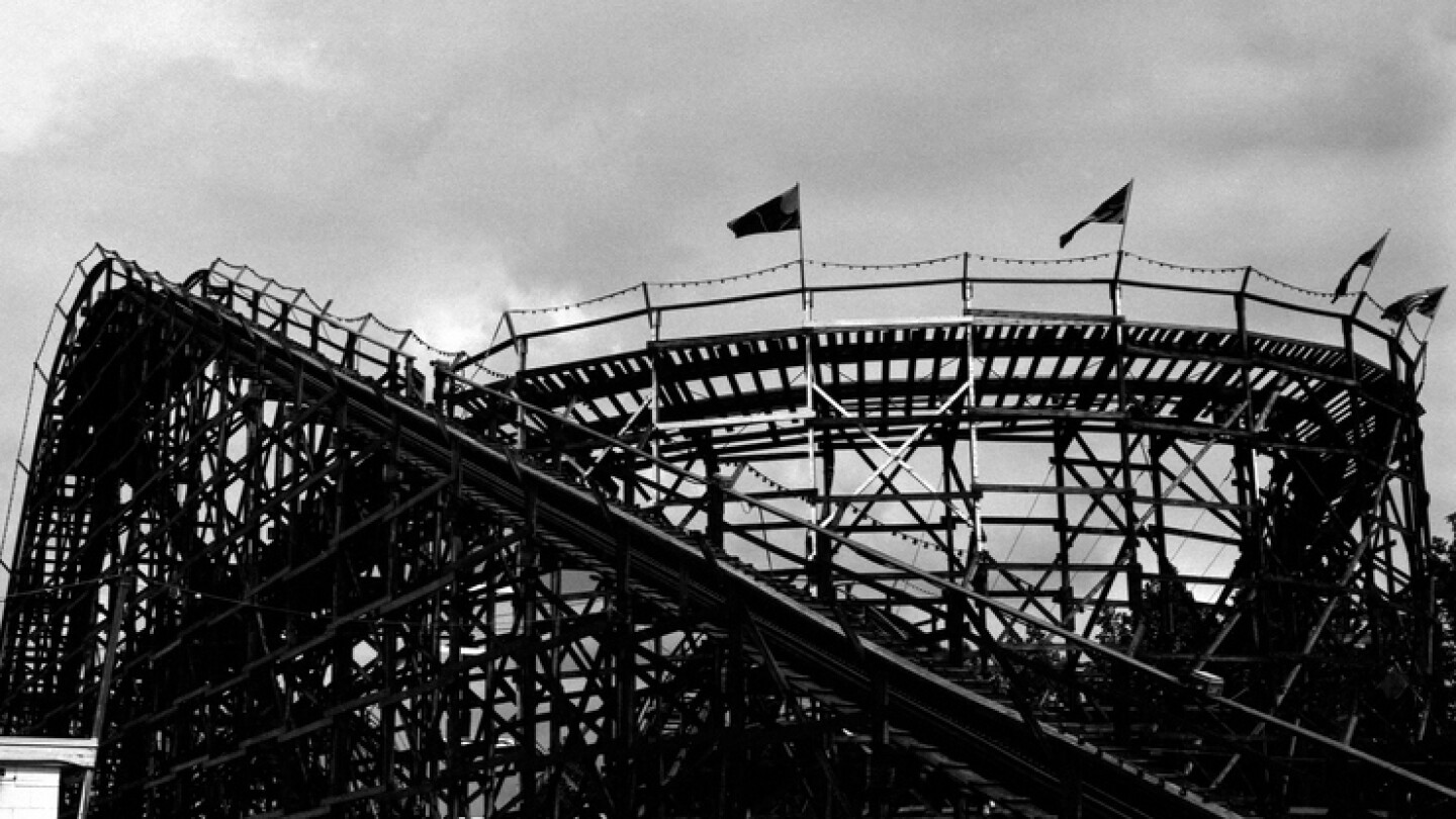 A silhouetted roller coaster, taken on high speed black and white film for dramatic effect.