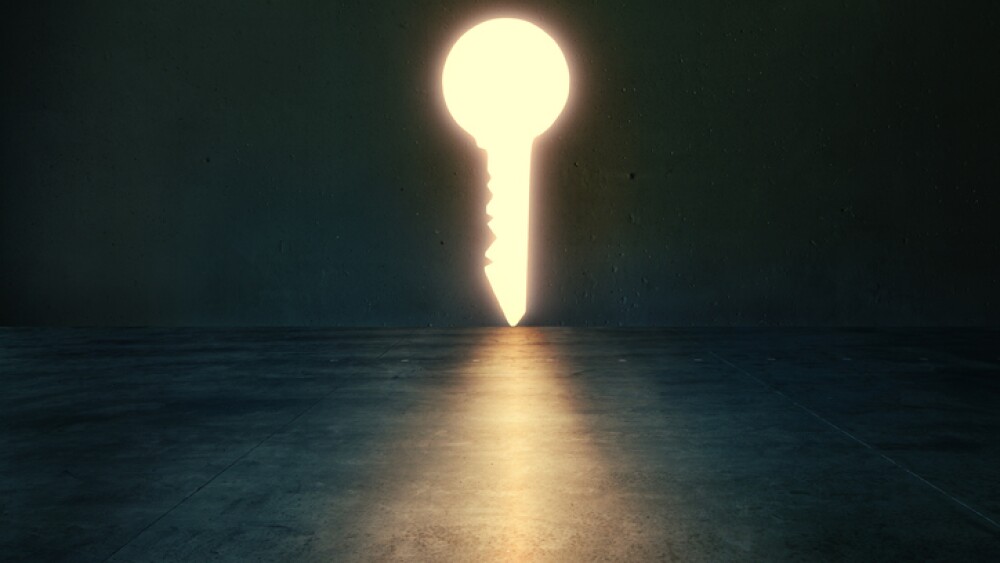 Glowing lights key shaped hole in dark empty room. Mystical and symbolic concept