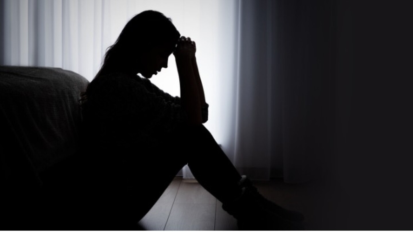 Pictured: A silhouette of a woman sitting on the f