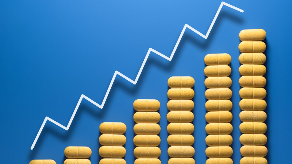 Yellow pills on blue background. Schedule Increase the dosage of drugs